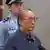 In this image made from China Central Television video, former Chinese Railways Minister Liu Zhijun attends his sentencing at a courtroom at Beijing No. 2 Intermediate People's Court in Beijing Monday, July 8, 2013. The official Xinhua News Agency said Liu was sentenced to death with a two-year reprieve by a court in Beijing on Monday. Such sentences usually are commuted to life in prison with good behavior. Liu, 60, who oversaw the ministry's high-profile bullet train development, was accused of taking massive bribes and steering lucrative projects to associates. Chinese characters at bottom reads "Former Railway Minister Liu Zhijun sentencing," "Taking bribes and abuse of power sentenced to suspended death sentence." (AP Photo/CCTV via AP Video) CHINA OUT, TV OUT pixel