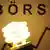 Energiesparlampe von Osram leuchtet vor dem Wort Börse (Foto: dpa)