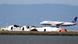 A United Airlines plane lands next to the wreckage of Asiana Flight 214 at the San Francisco International Airport in San Francisco, Sunday, July 7, 2013. (AP Photo/Marcio Jose Sanchez) A United Airlines plane lands next to the wreckage of Asiana Flight 214 at the San Francisco International Airport in San Francisco, Sunday, July 7, 2013. (AP Photo/Marcio Jose Sanchez)