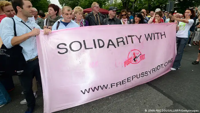 People protest against Russia's policies on homosexuality and display a banner declaring their solidarity with Russian Punk band during Berlin's annual Christopher Street Day (CSD) parade on June 23, 2012. Gays and lesbians all around the world are celebrating the Christopher Street Day (CSD) gay and lesbian pride parade, arguably the most important date in their calendar. AFP PHOTO / JOHN MACDOUGALL (Photo credit should read JOHN MACDOUGALL/AFP/GettyImages)