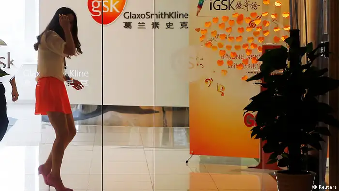 An employee walks inside a GlaxoSmithKline (GSK) office in Shanghai July 16, 2013. China must crack down on commercial bribery by multinational firms, the country's top state paper said on Wednesday, two days after police accused British drugmaker GlaxoSmithKline of the widespread bribery of Chinese officials and doctors. Picture taken July 16, 2013. REUTERS/Stringer (CHINA - Tags: BUSINESS HEALTH CRIME LAW) CHINA OUT. NO COMMERCIAL OR EDITORIAL SALES IN CHINA