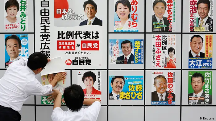 Staff members of Japan's ruling Liberal Democratic Party (LDP) post posters of election candidates at the LDP headquarters in Tokyo July 4, 2013, the start day of campaigning for the July 21 upper house election. Japanese Prime Minister Shinzo Abe, riding high in opinion polls on hopes he can revive a stagnant economy, urged voters on Thursday to back his ruling bloc in this month's upper house election and end a six-year policy deadlock. REUTERS/Yuya Shino (JAPAN - Tags: POLITICS ELECTIONS)