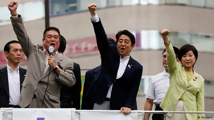 Japan's Prime Minister Shinzo Abe (C), who is also leader of the ruling Liberal Democratic Party, raises his fist with his party members at the start day of campaigning for the July 21 Upper house election in Tokyo July 4, 2013. Abe, riding high in opinion polls on hopes he can revive a stagnant economy, urged voters on Thursday to back his ruling bloc in this month's upper house election and end a six-year policy deadlock. REUTERS/Toru Hanai (JAPAN - Tags: POLITICS ELECTIONS)