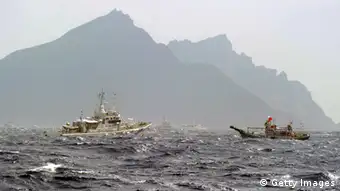 A Taiwan fishing boat (R) is blocked by a Japan Coast Guard (L) vessel near the disputed Diaoyu / Senkaku islands in the East China Sea on September 25, 2012. Coastguard vessels from Japan and Taiwan duelled with water cannon after dozens of Taiwanese boats escorted by patrol ships sailed into waters around Tokyo-controlled islands. Japanese coastguard ships sprayed water at the fishing vessels, footage on national broadcaster NHK showed, with the Taiwanese patrol boats directing their own high-pressure hoses at the Japanese ships. AFP PHOTO / Sam Yeh (Photo credit should read SAM YEH/AFP/GettyImages)
