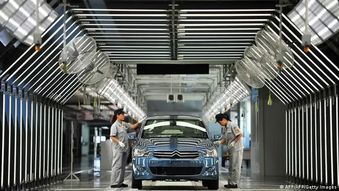 This picture taken on July 2, 2013 shows employees working on the production line in a new plant of Dongfeng Peugeot-Citroën Automobile Limited (DPCA) in Wuhan, central China's Hubei province. China's second biggest automaker, Dongfeng, has held talks about buying a stake in troubled French car firm PSA Peugeot Citroen, a state-backed newspaper said on July 3. CHINA OUT AFP PHOTO (Photo credit should read AFP/AFP/Getty Images)