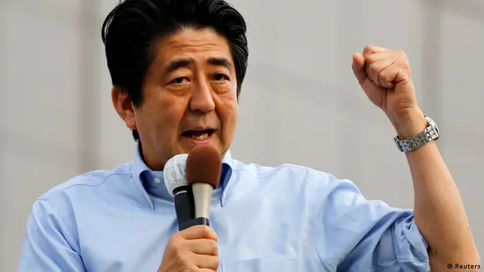 Japan's Prime Minister Shinzo Abe, who is also leader of the ruling Liberal Democratic Party, speaks to voters during a campaign for the July 21 Upper house election in Funabashi, east of Tokyo July 19, 2013. Japanese shares recoiled from a two-month high on Friday in a sudden reversal sparked by profit-taking before a weekend election that should see Abe gain control of the upper house of parliament. REUTERS/Toru Hanai (JAPAN - Tags: POLITICS ELECTIONS)
