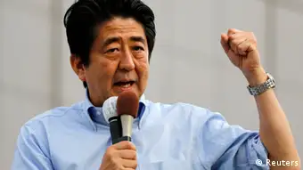 Japan's Prime Minister Shinzo Abe, who is also leader of the ruling Liberal Democratic Party, speaks to voters during a campaign for the July 21 Upper house election in Funabashi, east of Tokyo July 19, 2013. Japanese shares recoiled from a two-month high on Friday in a sudden reversal sparked by profit-taking before a weekend election that should see Abe gain control of the upper house of parliament. REUTERS/Toru Hanai (JAPAN - Tags: POLITICS ELECTIONS)