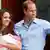 Britain's Prince William and his wife Catherine, Duchess of Cambridge appear with their baby son outside the Lindo Wing of St Mary's Hospital, in central London July 23, 2013. Kate gave birth to the couple's first child, who is third in line to the British throne, on Monday afternoon, ending weeks of feverish anticipation about the arrival of the royal baby. REUTERS/Andrew Winning (BRITAIN - Tags: ROYALS ENTERTAINMENT HEALTH)
