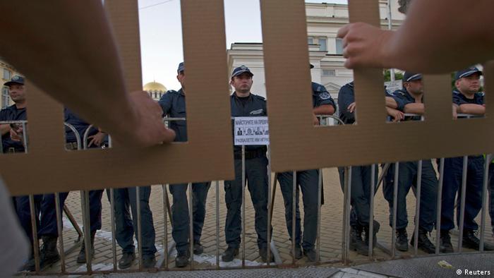 Protesters hold barricades made of cardboard in front of policemen during an anti-government demonstration in front of the parliament building in Sofia, July 24, 2013. (Photo: REUTERS/Stringer)