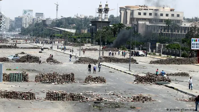 epa03803684 A general view shows road blocks at the area of clashes between police forces and supporters of ousted president Mohamed Morsi, near the tomb of former President Anwar al-Sadat, in Cairo, Egypt, 27 July 2013. Clashes between Egyptian police and backers of ousted Islamist president Mohammed Morsi in Cairo left 21 people dead, health authorities said on 27 July. Morsi_s Muslim Brotherhood put the toll at 120 people, saying they were killed in a _massacre_ by the army and police near an area in north-eastern Cairo where followers of the Islamist group have been camping and protesting for four weeks. The Health Ministry reported that about 180 were injured in the clashes that police said broke out after Morsi_s supporters tried to block the October 6 Bridge, which links Cairo_s east and south. EPA/KHALED ELFIQI