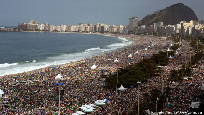 Hundreds of thousands of people crowd Copacabana beach in Rio de Janeiro on July 28, 2013 waiting for the arrival of Pope Francis for the final mass of his visit to Brazil. Throngs of pilgrims attending World Youth Day (WYD) spent the night sleeping on the beach before Sunday's final mass, while the city's mayor said he expects up to three million people to pack the beach for the occasion. AFP PHOTO / VANDERLEI ALMEIDA (Photo credit should read VANDERLEI ALMEIDA/AFP/Getty Images)