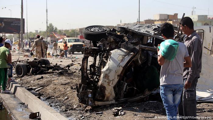 Iraqis inspect the site of a car bomb explosion in Sadr City in Baghdad AFP PHOTO/AHMAD AL-RUBAYE (Photo credit should read AHMAD AL-RUBAYE/AFP/Getty Images)