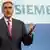 Berlin, GERMANY: New Siemens CEO Peter Loescher gestures during a press conference in Berlin 05 July 2007. Austrian-born Loescher, 49, took over as head of the scandal-ridden electrical engineering giant, succeeding Klaus Kleinfeld. AFP PHOTO JOHN MACDOUGALL (Photo credit should read JOHN MACDOUGALL/AFP/Getty Images)