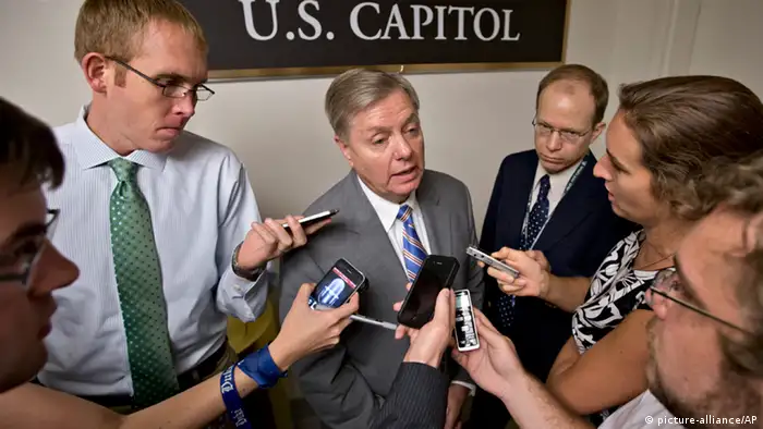 Sen. Lindsey Graham, R-S.C., center, is surrounded by reporters on Capitol Hill in Washington, Tuesday, July 30, 2013, during a roll call. Graham said on Tuesday that President Barack Obama has asked him and Sen. John McCain, R-Ariz. to travel to Egypt to urge the military to move ahead on elections. (AP Photo/J. Scott Applewhite)