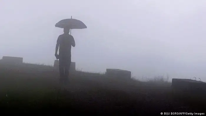 An Indian pedestrian walks through heavy fog at Mawsynram village in the north-eastern Indian state of Meghalaya and considered the wettest place on earth 