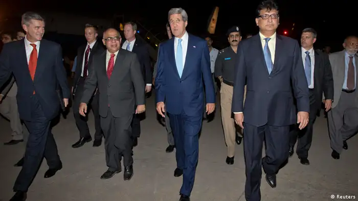 U.S. Secretary of State John Kerry (C) walks with U.S. Ambassador to Pakistan Richard Olson (L) and unidentified Pakistani officials upon his arrival in Islamabad July 31, 2013. Kerry is scheduled to meet with members of Pakistan's newly-elected civilian government on Thursday. REUTERS/Jason Reed (PAKISTAN - Tags: POLITICS)