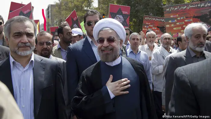 Iranian president-elect Hassan Rowhani (C) takes part in a parade marking Al-Quds (Jerusalem) International Day in Tehran on August 2, 2013. Rowhani said that Israel was a foreign body that must be removed, and also cast doubt on efforts to revive peace talks with the Palestinians. AFP PHOTO/ATTA KENARE (Photo credit should read ATTA KENARE/AFP/Getty Images)