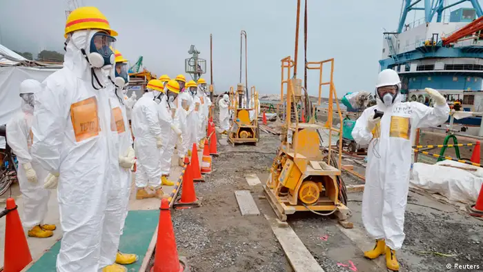 Members of a Fukushima prefecture panel, which monitors the safe decommissioning of the nuclear plant, inspect the construction site of the shore barrier, which is meant to stop radioactive water from leaking into the sea, near the No.1 and No.2 reactor building of the tsunami-crippled Fukushima Daiichi nuclear power plant in Fukushima, in this photo released by Kyodo August 6, 2013. Highly radioactive water seeping into the ocean from Japan's crippled Fukushima nuclear plant is creating an emergency that the operator is struggling to contain, an official from the country's nuclear watchdog said on Monday. Mandatory Credit. REUTERS/Kyodo (JAPAN - Tags: DISASTER BUSINESS POLITICS CONSTRUCTION HEALTH TPX IMAGES OF THE DAY) ATTENTION EDITOR - FOR EDITORIAL USE ONLY. NOT FOR SALE FOR MARKETING OR ADVERTISING CAMPAIGNS. THIS IMAGE HAS BEEN SUPPLIED BY A THIRD PARTY. IT IS DISTRIBUTED, EXACTLY AS RECEIVED BY REUTERS, AS A SERVICE TO CLIENTS. MANDATORY CREDIT. JAPAN OUT. NO COMMERCIAL OR EDITORIAL SALES IN JAPAN. YES