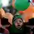 An Egyptian girl wears a headband with Arabic writing that reads " No God but Allah and Mohammed is his prophet," while playing with balloons as supporters of Egypt's ousted President Mohammed Morsi celebrate the first day of Eid al-Fitr holiday, marking the end of the Muslim holy fasting month of Ramadan that is traditionally celebrated with special cookies, presents and new clothes outside Rabaah al-Adawiya mosque, where protesters have installed a camp and hold daily rallies at Nasr City in Cairo, Egypt, Wednesday, Aug. 8, 2013. This year's holiday of Eid al-Fitr was overshadowed by the deep divisions in Egypt, with the interim government planning to celebrate the festival with outdoor prayers in town center squares and Morsi's supporters marking the holiday with their own protest marches gatherings, including at the two major sit-ins by the Islamists in Cairo. (AP Photo/Khalil Hamra)