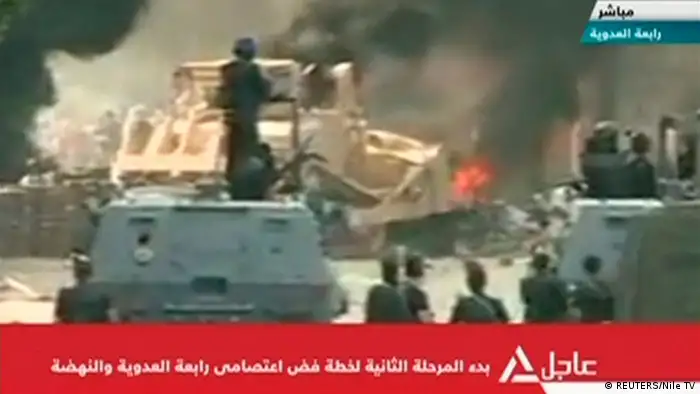ACHTUNG VIDEOSTILL SCHLECHTE QUALITÄT NICHT ALS ARTIKELBILD VERWENDEN A bulldozer demolishes a barricade at a protest camp set up by supporters of deposed Egyptian President Mohamed Mursi in Cairo August 14, 2013 in this still image taken from video. Egyptian security forces finished breaking up the smaller of two Cairo protest camps set up by supporters of deposed President Mohamed Mursi, state TV reported on Wednesday, after the police moved in the early hours against the sit-ins. REUTERS/Nile TV via Reuters TV (EGYPT - Tags: CIVIL UNREST POLITICS TPX IMAGES OF THE DAY) ATTENTION EDITORS - THIS IMAGE WAS PROVIDED BY A THIRD PARTY. FOR EDITORIAL USE ONLY. NOT FOR SALE FOR MARKETING OR ADVERTISING CAMPAIGNS. NO SALES. NO ARCHIVES. EGYPT OUT. THIS PICTURE IS DISTRIBUTED EXACTLY AS RECEIVED BY REUTERS, AS A SERVICE TO CLIENTS. NO COMMERCIAL OR EDITORIAL SALES IN EGYPT