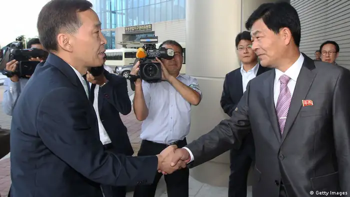KAESONG, NORTH KOREA - AUGUST 14: (SOUTH KOREA OUT) Kim Ki-Woong (L), the head of South Korea's working-level delegation shakes hands with his North Korean counterpart Park Chol-Su (R) during their meeting at Kaesong Industrial District Management Committee on August 14, 2013 in Kaesong, North Korea. North Korea withdrew over 50,000 of its staff from the factories owned by Seoul in April of this year, and South Korea removed managers in May, during the height of tensions between the two nations. (Photo by Lee Seung-Hwan-Korea Pool/Getty Images)