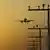 Літак у небі на тлі опор електромереж (символічне фото)