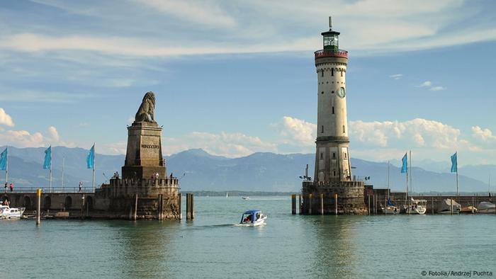 The harbor entrance of Lindau on Lake Constance, with the Alps in the background