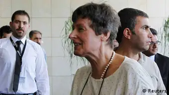 A U.N. employee welcomes Angela Kane (front R), head of the U.N. Office of Disarmament Affairs, as she arrives in Damascus July 24, 2013. Kane and Ake Sellstrom, head of a U.N. chemical weapons investigation team, arrived in Syria on Wednesday to discuss the later's inquiry into allegations that chemical arms have been used in Syria's civil war. Kane said on her arrival in Damascus that their mission was to prepare the ground for an investigation into chemical weapons use. REUTERS/Khaled al-Hariri (SYRIA - Tags: POLITICS CIVIL UNREST CONFLICT)