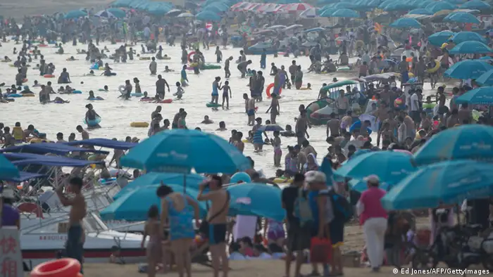 A general view shows holiday-makers on a beach at the seaside town of Beidaihe, 100 kms (60 miles) east of Beijing on August 6, 2012. China's leaders, including the man expected to be the next president, have begun their secretive summer meetings at the seaside resort, state press said on August 5, ahead of a once-in-a-decade transition of power. AFP PHOTO / Ed Jones (Photo credit should read Ed Jones/AFP/GettyImages)
