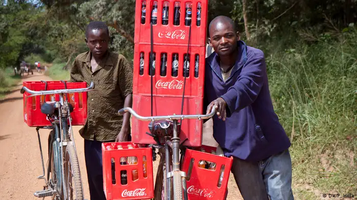 Africans transporting Coca-Cola by bicycle.