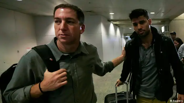 U.S. journalist Glenn Greenwald (L) walks with his partner David Miranda in Rio de Janeiro's International Airport August 19, 2013. British authorities used anti-terrorism powers on Sunday to detain Miranda, the partner of Greenwald, who has close links to Edward Snowden, the former U.S. spy agency contractor who has been granted asylum by Russia, as he passed through London's Heathrow airport. The 28-year-old Miranda, a Brazilian citizen and partner of Greenwald who writes for Britain's Guardian newspaper, was questioned for nine hours before being released without charge, a report on the Guardian website said. REUTERS/Ricardo Moraes (BRAZIL - Tags: POLITICS CRIME LAW TPX IMAGES OF THE DAY MEDIA)