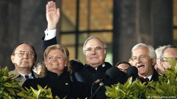 German Chancellor Helmut Kohl (c.) at an event marking German reunification on October 3, 1990