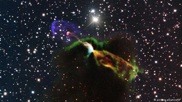 This image made available by the European Southern Observatory on Tuesday, Aug. 20, 2013 using radio and visible light frequencies shows the Herbig-Haro object HH 46/47. The orange and green, lower right, of the newborn star reveal a large energetic jet moving away from the Earth, which in the visible is hidden by dust and gas. To the left, in pink and purple, the visible part of the jet is seen, streaming partly towards the Earth. Astronomers say these illuminated jets from the newborn star are spewing out faster than ever measured before and are more energetic than previously thought. (AP Photo/ESO/ALMA (ESO/NAOJ/NRAO)/H. Arce, Bo Reipurth)