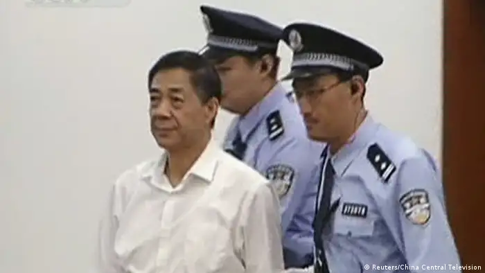 Bo Xilai (C), former Communist Party chief of the southwestern city of Chongqing, is escorted into court by two police officers during his trial in Jinan, Shandong province, August 22, 2013, in this still image taken from China Central Television (CCTV). Fallen Chinese politician Bo Xilai denied one of the bribery charges against him on Thursday as he appeared in public for the first time in more than a year to face China's most political trial in over three decades. REUTERS/China Central Television (CCTV) via Reuters TV (CHINA - Tags: CRIME LAW POLITICS) ATTENTION EDITORS - THIS IMAGE WAS PROVIDED BY A THIRD PARTY. FOR EDITORIAL USE ONLY. NOT FOR SALE FOR MARKETING OR ADVERTISING CAMPAIGNS. NO ARCHIVES. NO SALES. THIS PICTURE IS DISTRIBUTED EXACTLY AS RECEIVED BY REUTERS, AS A SERVICE TO CLIENTS.CHINA OUT. NO COMMERCIAL OR EDITORIAL SALES IN CHINA