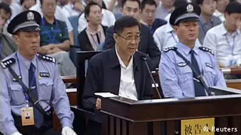 Ousted Chinese politician Bo Xilai speaks in court on the third day of his trial in Jinan, Shandong Province, in this still image taken from video shot on August 24, 2013. Bo Xilai accepted responsibility for 5 million yuan ($817,000) in funds he is accused of embezzling which ended up in his wife's bank account, saying he had let his attention wander, in testimony read out in court on Saturday. Bo, once a rising star in China's leadership, is facing charges of corruption, bribery and abuse of power. REUTERS/CCTV via Reuters TV (CHINA - Tags: POLITICS CRIME LAW IMAGES OF THE DAY) ATTENTION EDITORS � THIS IMAGE WAS PROVIDED BY A THIRD PARTY. NO SALES. NO ARCHIVES. FOR EDITORIAL USE ONLY. NOT FOR SALE FOR MARKETING OR ADVERTISING CAMPAIGNS. CHINA OUT. NO COMMERCIAL OR EDITORIAL SALES IN CHINA. THIS PICTURE IS DISTRIBUTED EXACTLY AS RECEIVED BY REUTERS, AS A SERVICE TO CLIENTS