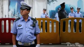 JINAN, CHINA - AUGUST 25: Chinese policemen guard outside the Jinan Intermediate People's Court during the fourth day of former Chinese politician Bo Xilai's trial on August 25, 2013 in Jinan, China. Ousted Chinese politician Bo Xilai is standing trial on charges of bribery, corruption and abuse of power for a third day. Bo Xilai made global headlines last year when his wife Gu Kailai was charged and convicted of murdering British businessman Neil Heywood. (Photo by Feng Li/Getty Images)