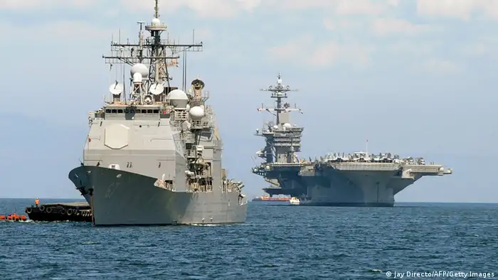 The US aircraft carrier Carl Vinson (R) and the cruiser USS Bunker Hill (L) sit anchored off Manila Bay after arriving on May 15, 2011 for a four-day port of call accompanied by three other warships. The Carl Vinson is making a port call in the Philippine capital after its crew buried Osama bin Laden's remains in the Arabian Sea AFP PHOTO / JAY DIRECTO (Photo credit should read JAY DIRECTO/AFP/Getty Images)