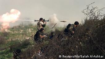 An image grab taken from a video shows an opposition fighter firing an rocket propelled grenade (RPG) on August 26, 2013 during clashes with regime forces over the strategic area of Khanasser, situated on the only road linking Aleppo to central Syria. Rebels had in recent days captured several villages in Aleppo province, much of which is already in the hands of anti-regime fighters, before taking Khanasser, situated on the highway to Hama in central Syria, thus cutting the army's only supply route to the northern province. AFP PHOTO / SALAH AL-ASHKAR (Photo credit should read SALAH AL-ASHKAR/AFP/Getty Images)