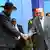 South Sudan's President Salva Kiir (3rd L) shakes hands with Sudan's President Omar al-Bashir as he arrives for talks at Khartoum Airport, Sepember 3, 2013. Diplomats hope what is only Kiir's second visit to Khartoum since South Sudan's secession in 2011 will help build trust between the neighbours, who fought one of Africa's longest civil wars that ended in 2005. REUTERS/Mohamed Nureldin Abdallah (SUDAN - Tags: POLITICS)