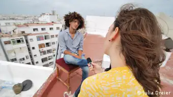 Young reporter conducting interview on a rooftop in Morocco