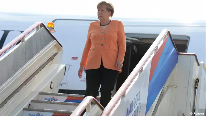 German Chancellor Angela Merkel walks downstairs as she arrives to take part in the G20 Summit in St. Petersburg, September 5, 2013. REUTERS/Alexei Filippov/RIA Novosti/Pool (RUSSIA - Tags: POLITICS BUSINESS) ATTENTION EDITORS - THIS IMAGE HAS BEEN SUPPLIED BY A THIRD PARTY. IT IS DISTRIBUTED, EXACTLY AS RECEIVED BY REUTERS, AS A SERVICE TO CLIENTS