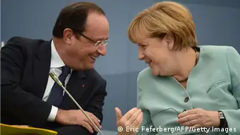 Frances President Francois Hollande (L) smiles while talking to Germanys Chancellor Angela Merkel as they attend a meeting with Business 20 and Labour 20 representatives during the G20 summit on September 6, 2013 in Saint Petersburg. AFP PHOTO / ERIC FEFERBERG (Photo credit should read ERIC FEFERBERG/AFP/Getty Images)