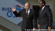 Russias President Vladimir Putin (L) welcomes Senegal's President Macky Sall (R) at the start of the G20 summit on September 5, 2013 in Saint Petersburg. Russia hosts the G20 summit hoping to push forward an agenda to stimulate growth but with world leaders dis AFP PHOTO / ERIC FEFERBERG (Photo credit should read ERIC FEFERBERG/AFP/Getty Images)