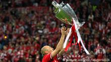 Arjen Robben holds the Champions League trophy aloft