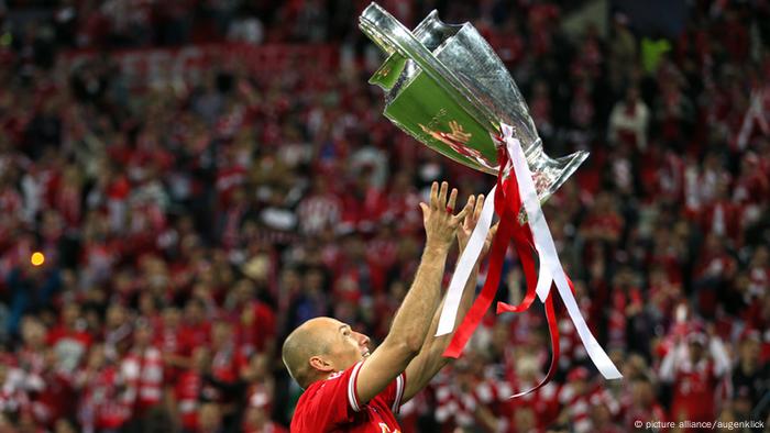 Arjen Robben holds the Champions League trophy aloft