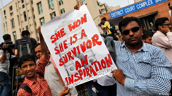 Demonstrators hold a placard outside a court in New Delhi September 13, 2013. All four men convicted of raping and murdering a 23-year-old woman in New Delhi were sentenced to death on Friday, a decision the judge said sent a message to society that there can be no tolerance for such a savage crime. REUTERS/Adnan Abidi (INDIA - Tags: CRIME LAW SOCIETY)