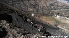 An Afghan miner walks up a slope with his donkeys loaded with coal outside a coal mine in Samangan province, north of Kabul on April 3, 2012. Afghanistan is believed to have mineral reserves worth as much as 3 trillion USD which could theoretically generate billions of dollars in tax revenue for the troubled country. AFP PHOTO/Qais Usyan (Photo credit should read QAIS USYAN/AFP/Getty Images)