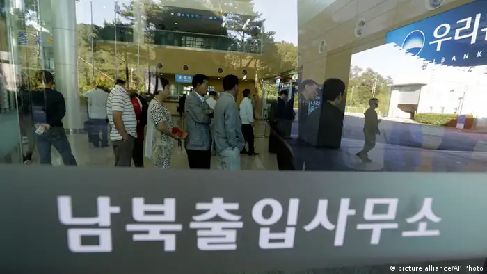 South Koreans wait in line to exchange money in front of a bank before leaving for the Kaesong Industrial Complex at the Inter-Korean Transit Office near the border village of Panmunjom, which has separated the two Koreas since the Korean War, in Paju, north of Seoul, South Korea, Monday, Sept. 16, 2013. North and South Korea agreed last week to restart operations at the jointly run factory park that Pyongyang shut down in April during a torrent of threats, the latest sign of easing animosity between the rivals. The writing reads Inter-Korean Transit Office. (AP Photo/Lee Jin-man)