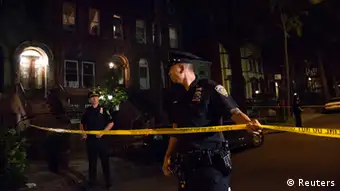 Policemen string police tape outside the Brooklyn residence Cathleen Alexis, mother of suspected Washington Navy Yard shooter Aaron Alexis, in New York September 16, 2013. A U.S. military veteran opened fire at the Washington Navy Yard on Monday in a burst of violence that killed 13 people, including the gunman, and set off waves of panic at the military installation just miles from the White House and U.S. Capitol. The FBI identified the suspect as Aaron Alexis, 34, of Fort Worth, Texas, a Navy contractor who had two gun-related brushes with the law. REUTERS/Andrew Kelly (UNITED STATES - Tags: CRIME LAW)
