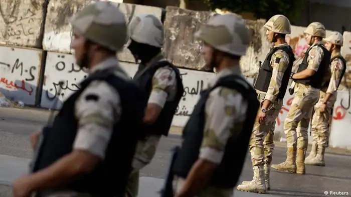 Egyptian army soldiers stand guard in front of El-Thadiya presidential palace during a protest by members of the Muslim Brotherhood and supporters of ousted Egyptian President Mohamed Mursi in Cairo, August 30, 2013. Thousands of supporters of Mursi marched through Cairo and cities across Egypt on Friday to demand his reinstatement, in the movement's biggest show of defiance since hundreds of protesters were killed two weeks ago. REUTERS/Amr Abdallah Dalsh (EGYPT - Tags: POLITICS CIVIL UNREST MILITARY)